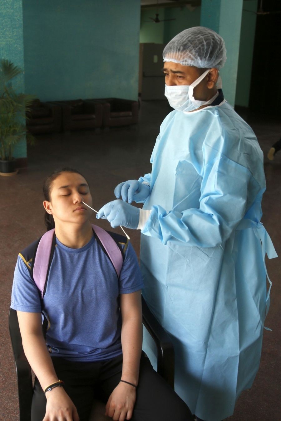 New Delhi: A health worker collects a nasal sample from a sports woman for the RT-PCR test of Covid-19 at the hostel of Indira Gandhi Indoor stadium in New Delhi on Thursday, May 05, 2022. (Photo: Qamar Sibtain/IANS)